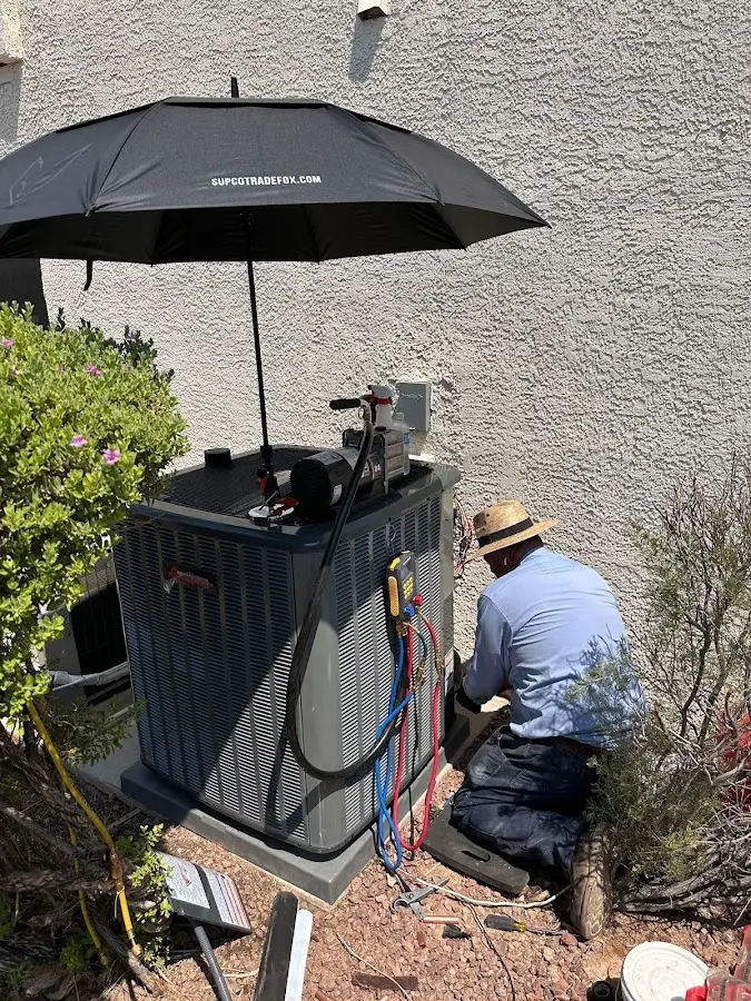 HVAC technician performing outdoor AC maintenance in New Castle